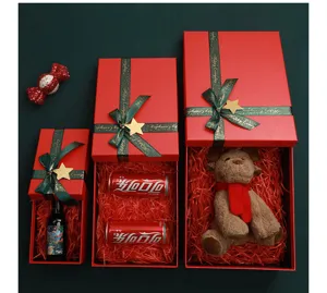 Red Christmas gift boxes set with lids, decorative ribbons and stars for holiday packaging.