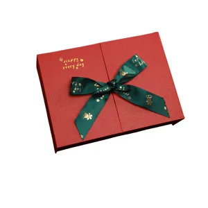 Christmas red gift box with green ribbon, large decorative box for festive holiday presents.
