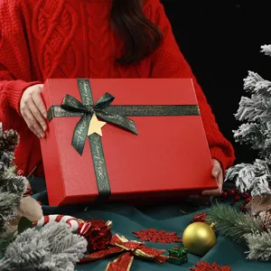 Festive red gift box with green ribbon and star pendant, perfect for Christmas present.