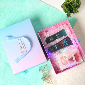 Pink and blue gradient gift box set with cosmetic tubes and decorative lights for Valentine's Day.