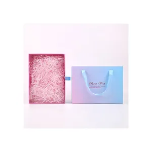Pink blue gradient gift box with shred paper and ribbon handle for cosmetic packaging and romance.