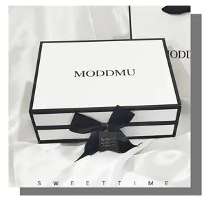 Minimalist black and white gift box, elegant rectangular cosmetic packaging with ribbon detail.
