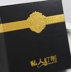 Close-up detail of luxury black and gold gift box with exquisite bronzing texture design.