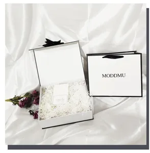 Minimalist black and white gift box set with paper bag and ribbon for cosmetic packaging.