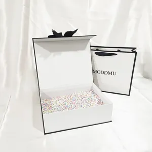 Large black and white flip top gift box with ribbon and colorful foam ball fillers.
