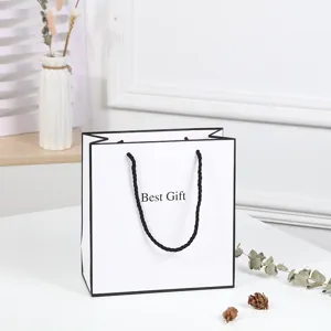 White paper gift bag with black borders, large minimalist shopping tote for retail packaging.