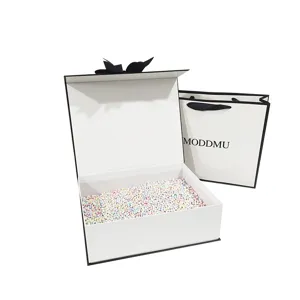 Minimalist black and white gift box with lid and matching paper bag for cosmetics.