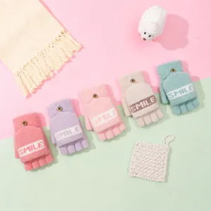 Detail view of cozy knit half-finger flip-cover gloves with smile pattern for winter warmth.