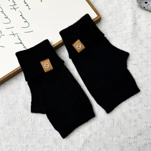 Winter warm black knit fingerless gloves for women, thick wool half finger gloves for cold days.