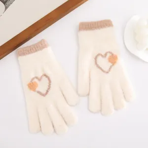 Cozy knitted winter gloves with cute heart pattern detail, thick thermal warmth for cold days.