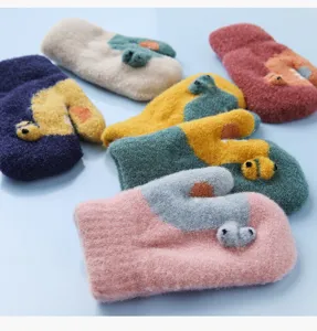 Detailed close-up of cute cartoon plush children winter warm mittens with cute animal design.