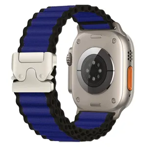 Blue and black woven nylon watch band with a metallic parachute buckle, showing detailed view.