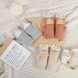 Kids knit half-finger gloves detail shot showcasing cute animal cartoon design and warm material.