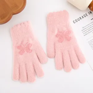 Pink knitted winter gloves detail showing cute butterfly jacquard and thick warm wool material.