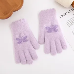 Close up detail of light purple fuzzy knit gloves featuring cute butterfly jacquard pattern.