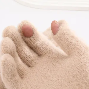 Close-up detail of thermal fleece knit split finger gloves in beige, soft texture for winter.