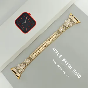 Elegant metal watch band compatible with Apple Watch, featuring sparkling rhinestone clover charms.