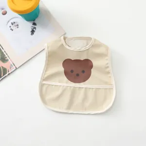 Detailed view of cute bear waterproof baby bib in beige, perfect for mess-free feeding times.