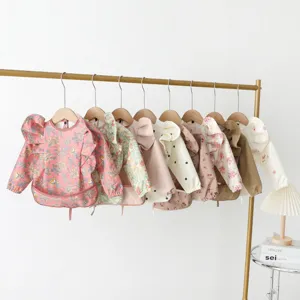 Bavoir imperméable à manches longues pour bébé avec ailes d'ange, idéal pour les repas quotidiens.