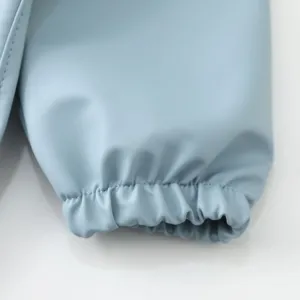 Light blue waterproof baby bib sleeve cuff detail, ultra-soft fabric with elastic band.