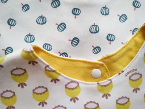 Soft cotton baby bib with snap button and cute print, comfortable and safe infant saliva towel.