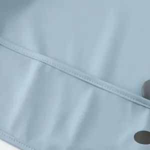 Waterproof baby bib fabric detail close-up soft material smooth texture light blue baby smock