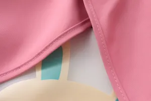 Children waterproof smock detail shot, cute cartoon rabbit pattern, pink fabric bib.