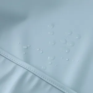 Close up of baby waterproof bib fabric showing water repellent drops and neat stitching details.