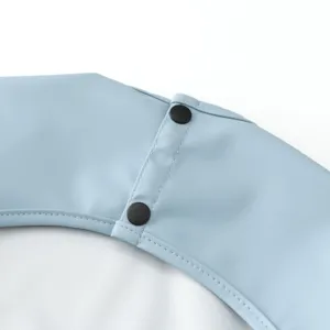 Waterproof baby feeding bib detail view, soft waterproof material with secure snap buttons.