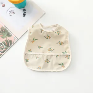 Close-up view showing the cute olive print pattern, waterproof fabric and pocket design of baby bib.