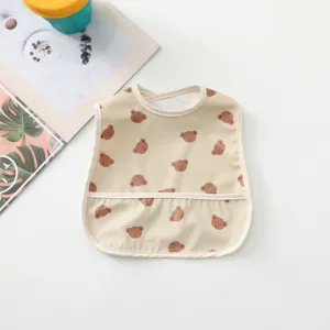 Waterproof baby bib with cute bear pattern, front crumb catcher pocket for easy feeding time.