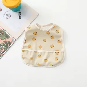 Waterproof baby bib with cute bear print and deep crumb catcher pocket detail view.