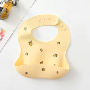 Cute lemon print silicone baby bib with crumb catcher and adjustable snap buttons for toddlers.