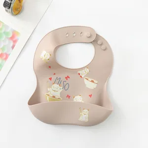 Waterproof silicone baby bib with cute cat print, soft food grade material, easy to clean.
