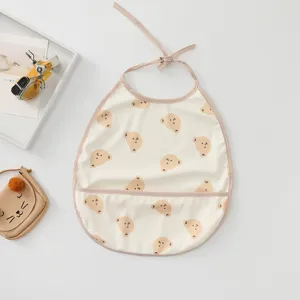 Waterproof baby bib with cute bear pattern, food catcher pocket, and convenient neck ties.