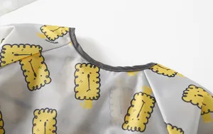 Detailed view of waterproof baby long sleeve smock featuring adorable lion prints.