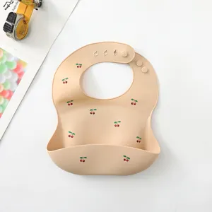 Waterproof silicone baby bib with cute cherry pattern, soft crumb catcher, adjustable.