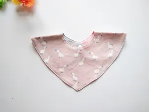 Detailed view of soft cotton baby triangle bib with cute duck pattern and snap button.