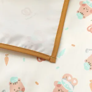 Waterproof baby urine pad detail, cute cartoon bear pattern with neat brown binding and stitching.