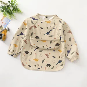 Waterproof long sleeve baby bib with cute dinosaur print, soft PU feeding smock for toddlers.