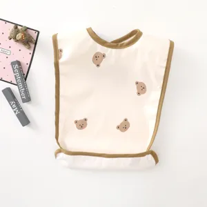 Cute baby waterproof feeding bib detail with lovely bear print and brown trim design.