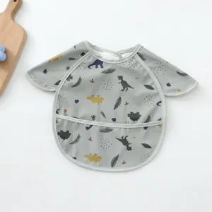 Waterproof PU baby long sleeve coverall bib with cute dinosaur pattern and catch pocket.