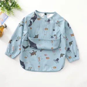 Details of the waterproof baby long-sleeve feeding bib featuring cute ocean animal prints.