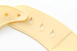 Waterproof silicone baby bib in soft pastel yellow with adjustable button closure for kids.