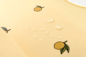 Waterproof silicone baby bib detail with cute lemon pattern, soft and easy to clean.