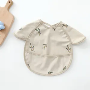 Waterproof baby PU smock detail view, featuring cute olive branch print and food catcher pocket.