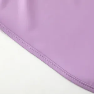 Waterproof baby bib smock detail shot featuring durable purple fabric with neat stitching.
