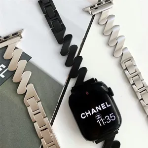 Close-up detail of Z-shaped metal Mobius watch band for Apple Watch, unique twisted link texture.