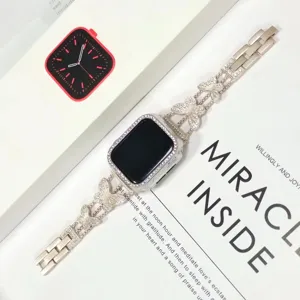 Exquisito detalle de correa de metal con diamantes de imitación de mariposa para Apple Watch.