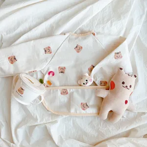 Detailed shot of waterproof baby long sleeve coverall bib with cute bear pattern and crumb catcher.
